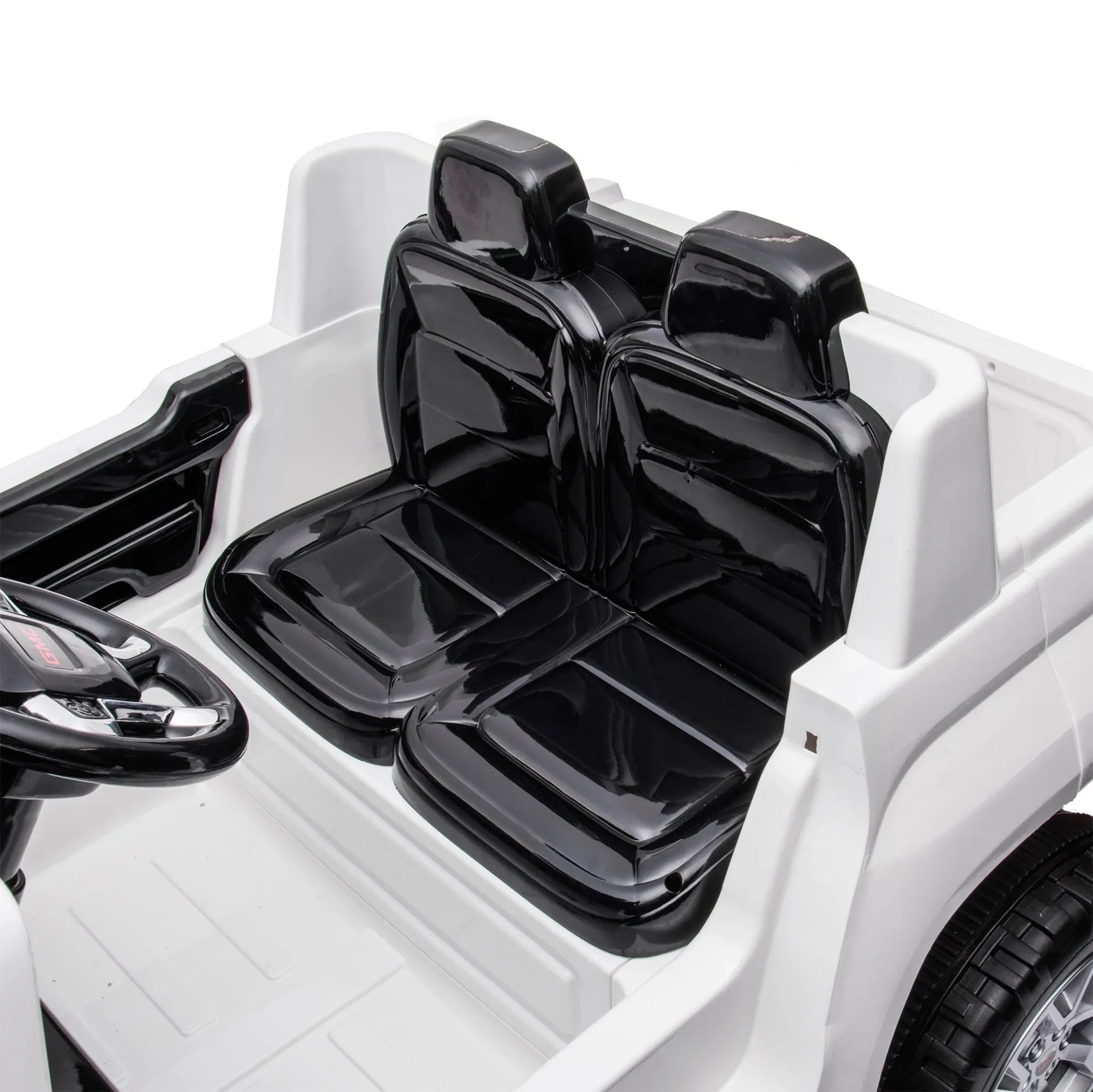 Black leather-look seats inside white toy ride-on car