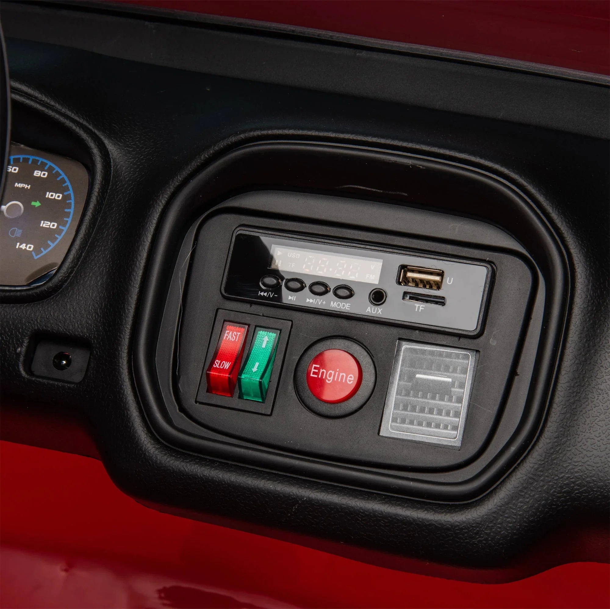 Close-up of kids electric ride-on car dashboard with speed switches, engine button, USB port, and controls.