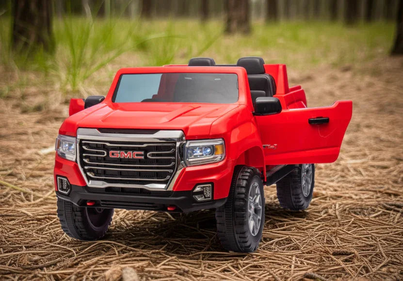 Red GMC toy truck with open door parked on pine forest ground