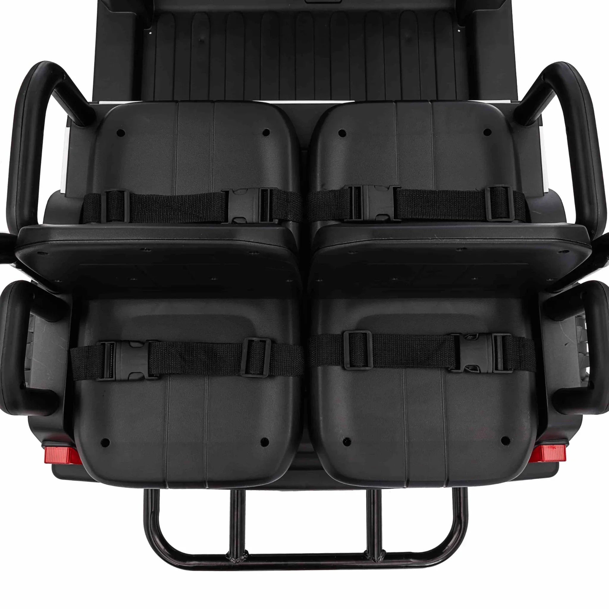 Top view of four black seats with seat belts in a 24V electric buggy for kids