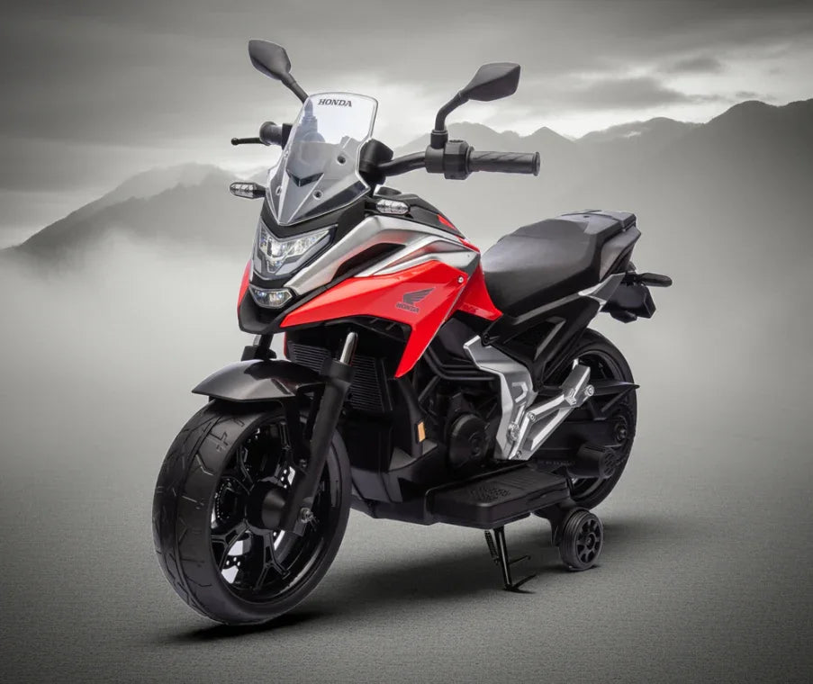 Red and black Honda kids electric bike with training wheels, mountain background