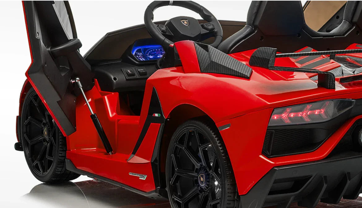 Red Lamborghini ride-on toy car with open scissor door and black sport interior