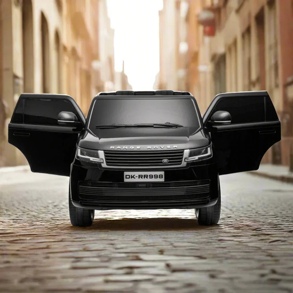 Black Range Rover toy car with open doors on cobblestone street, front view