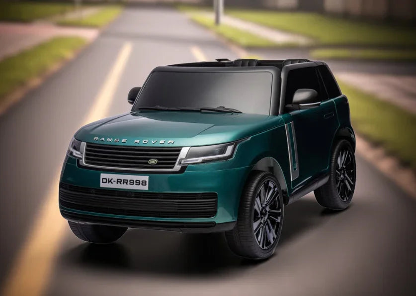 Green toy Range Rover ride-on car on an outdoor road, kids electric vehicle