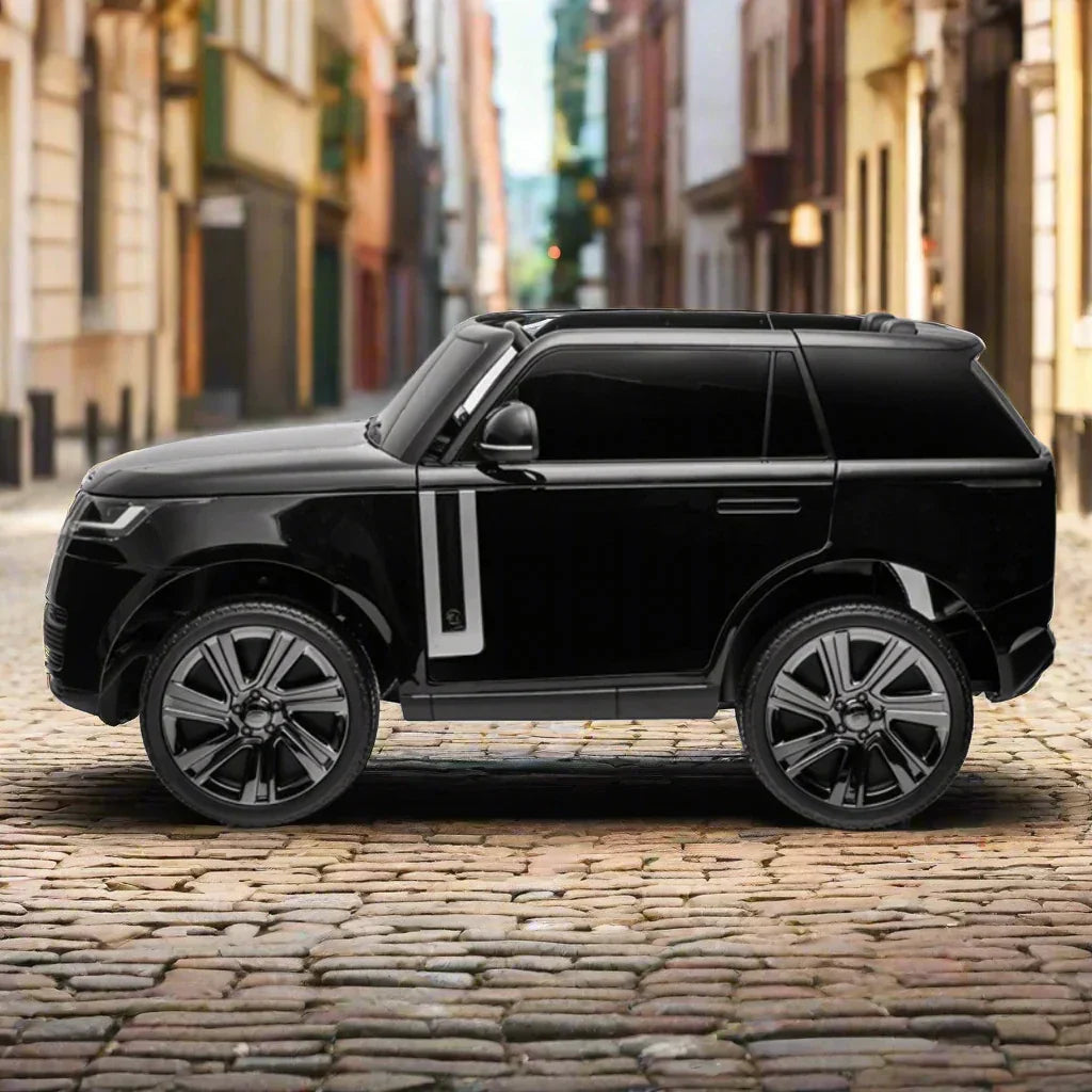 Black luxury toy SUV car on cobblestone street in urban city setting