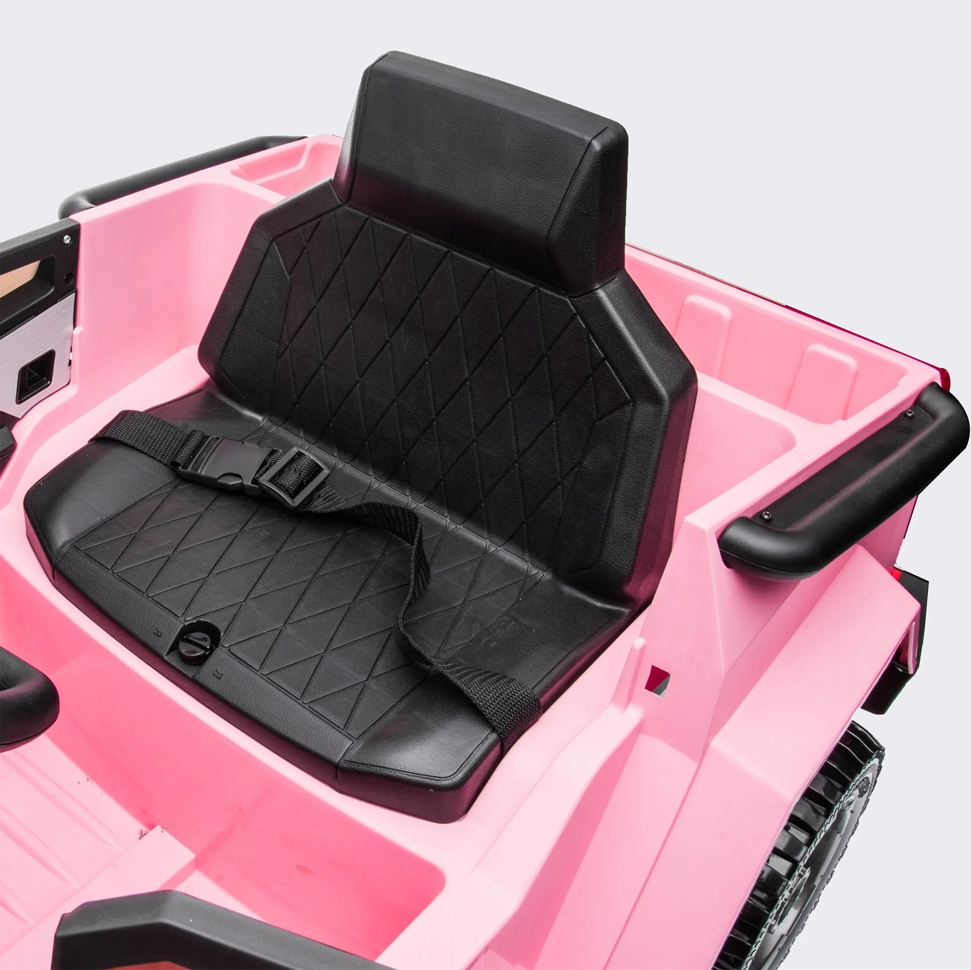 Black seat with seatbelt in pink kids ride on car, close-up, plastic toy vehicle interior