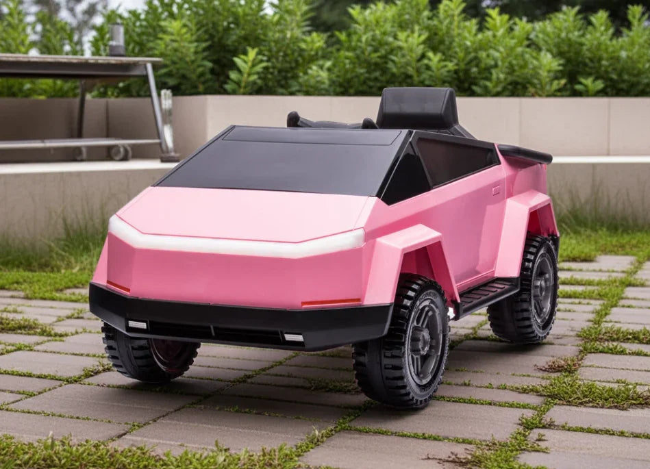 Pink toy cybertruck ride-on car on patio with greenery in the background