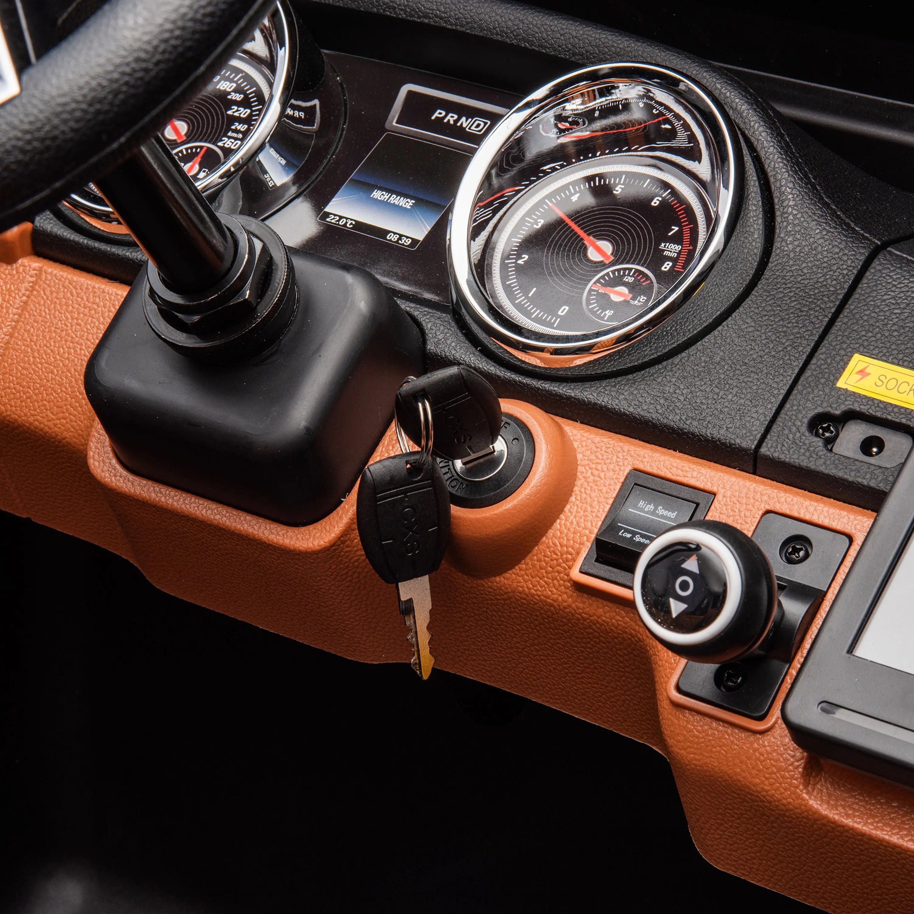 Close-up of a vehicle dashboard with key in ignition, steering column, and control dials