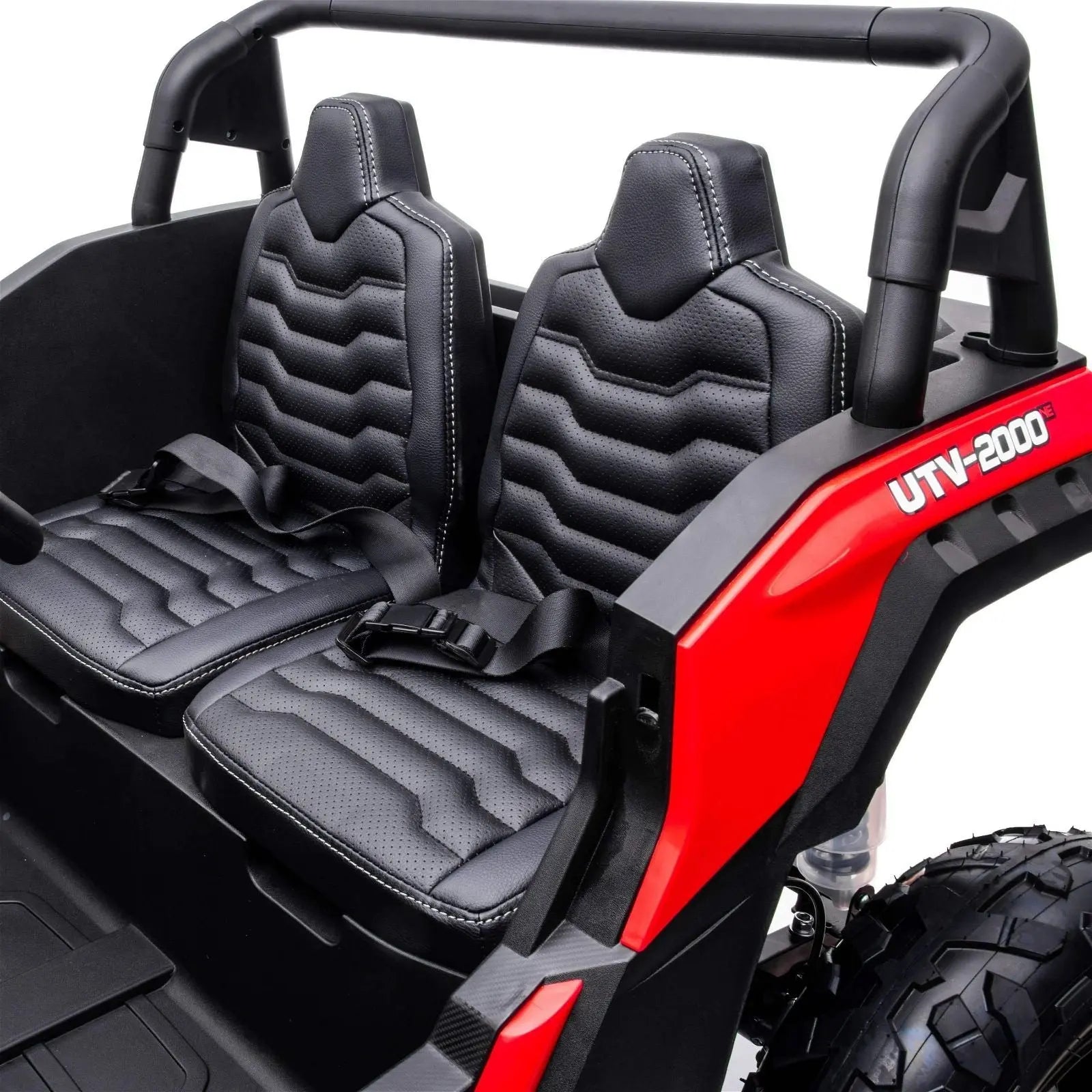 Close-up of two black seats with harnesses in a red 2-seater kids' ride-on dune buggy