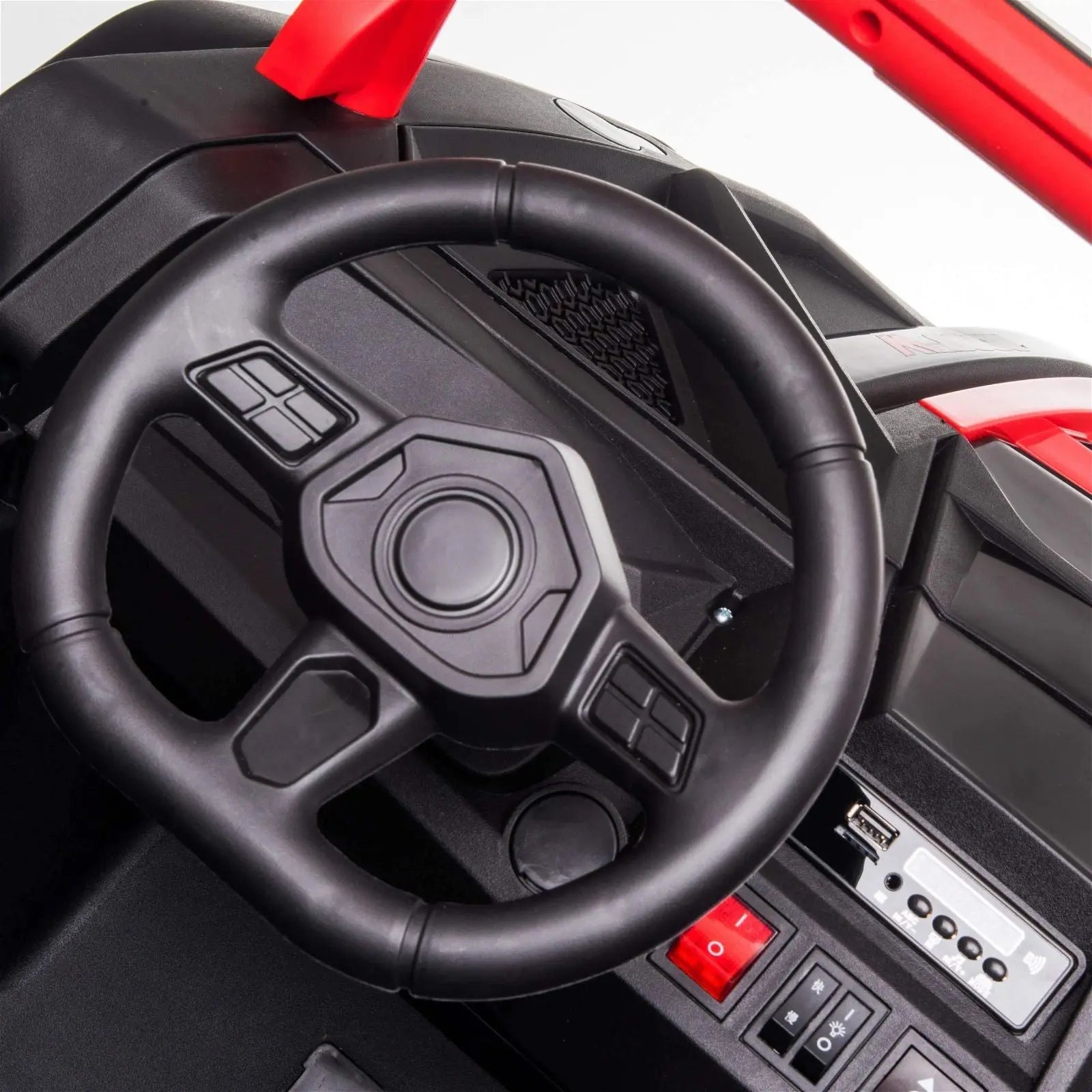 Close-up of a kids' electric ride-on dune buggy steering wheel and dashboard controls