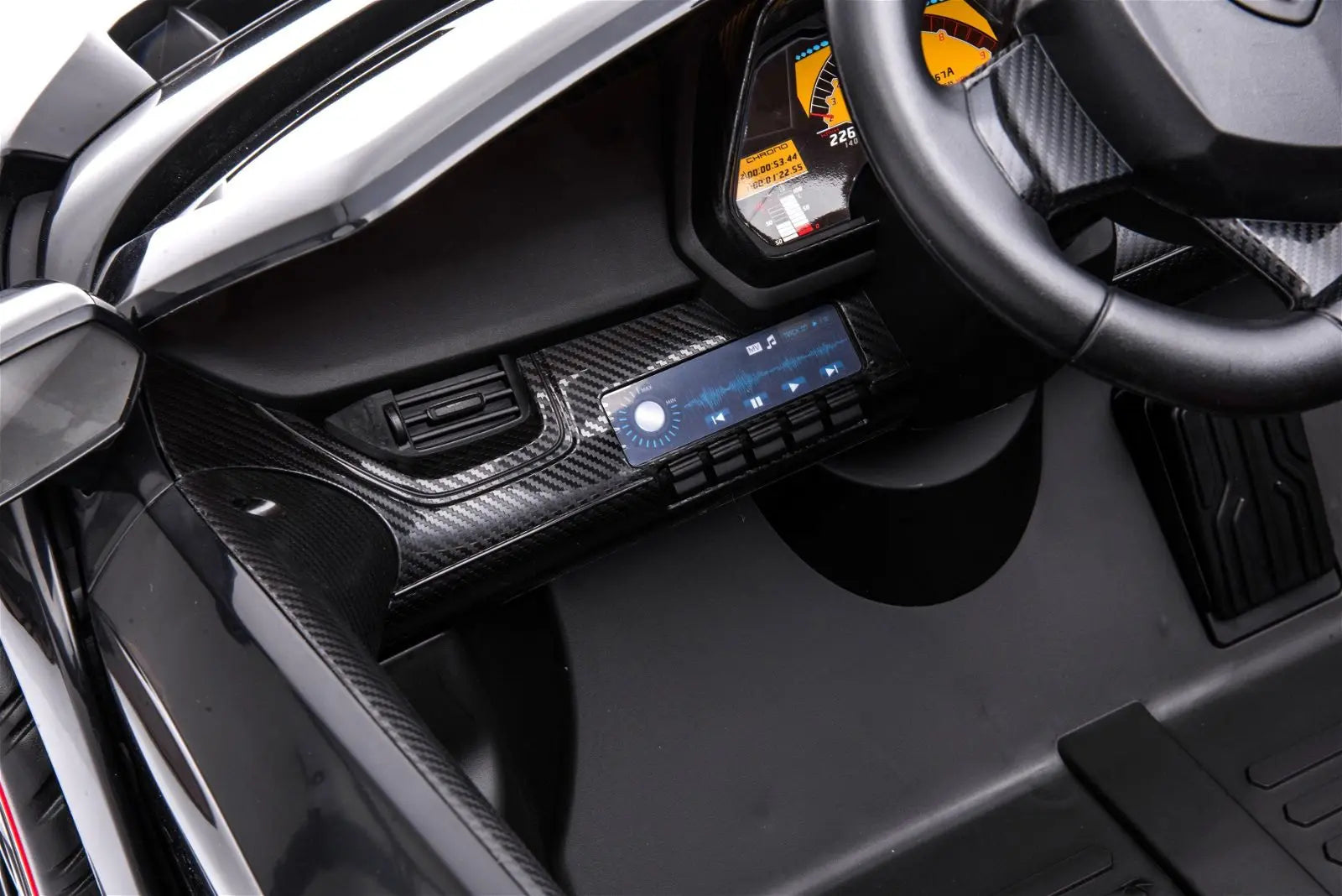 Close-up of toy ride-on car dashboard with digital controls and realistic steering wheel