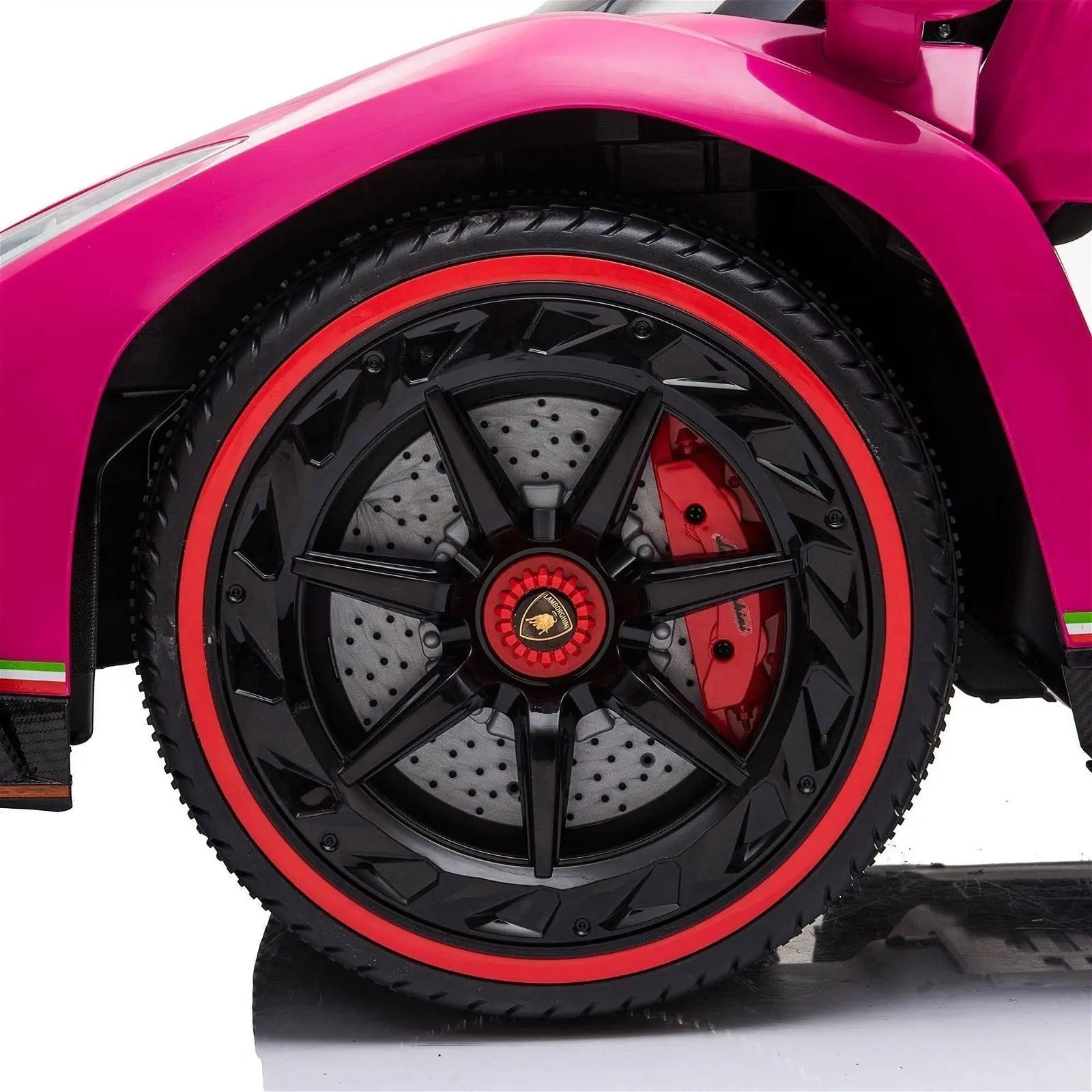 Close-up of black and red wheel on pink Lamborghini Veneno ride-on toy car