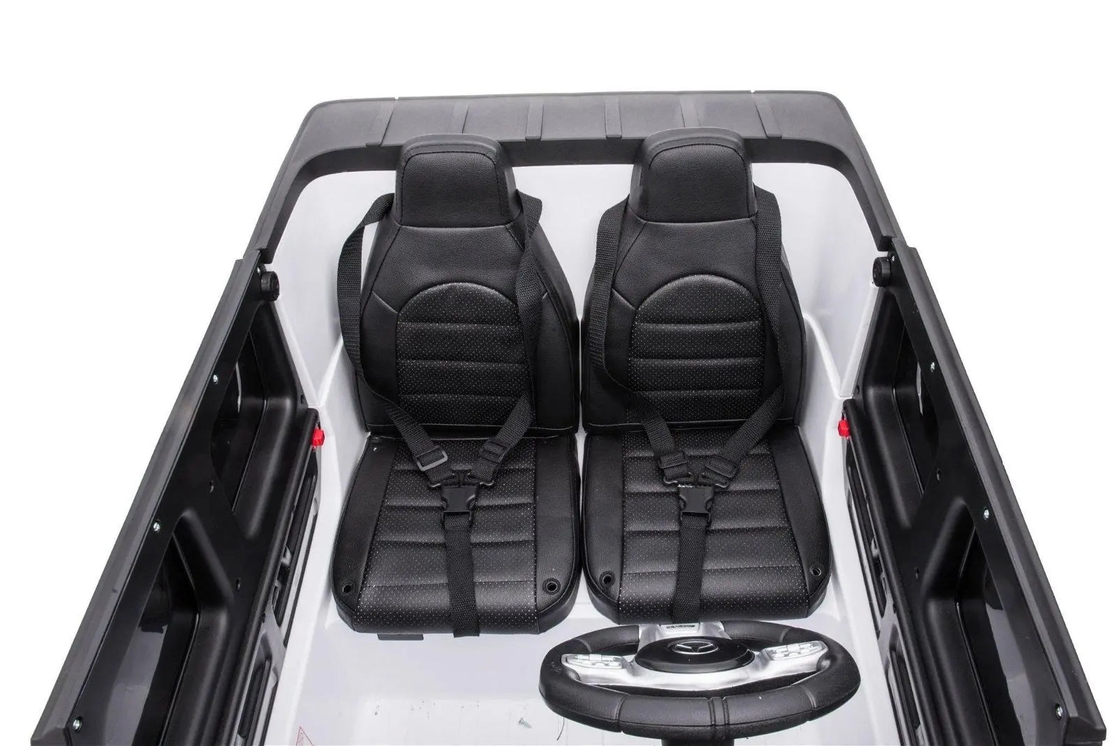 Black leather-style two-seater ride on car interior with seat belts and steering wheel