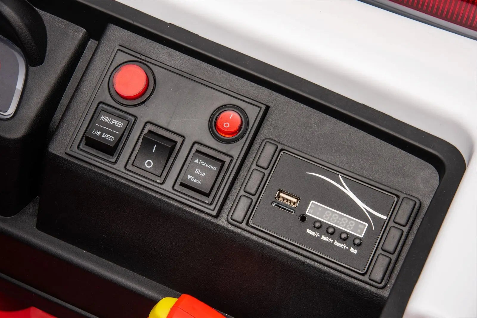 Close-up of ride-on fire truck dashboard with speed controls, buttons, and USB port