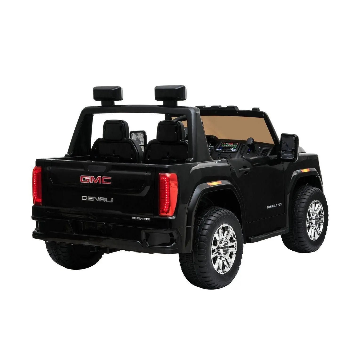 Black 2-seater GMC Denali ride-on toy car with chrome wheels, shown from rear angle.