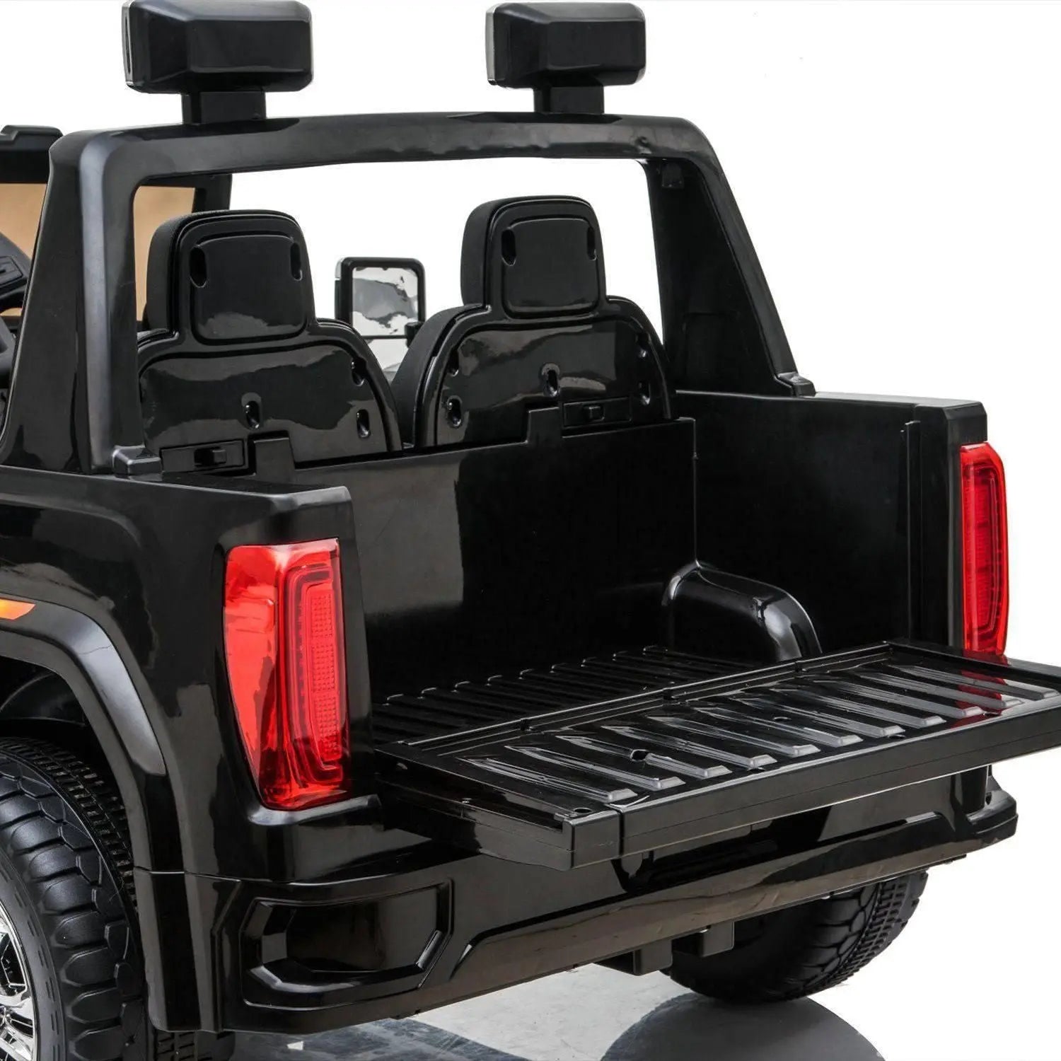 Rear view of black 2-seater kids ride on toy truck with open tailgate and visible seats