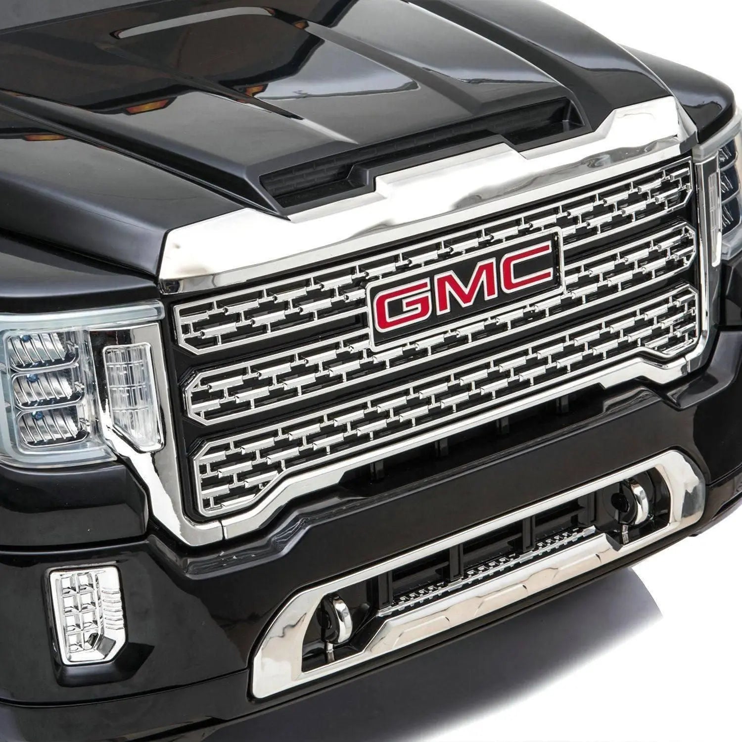 Close-up of black GMC Denali toy car grille and headlights, detailed chrome front design