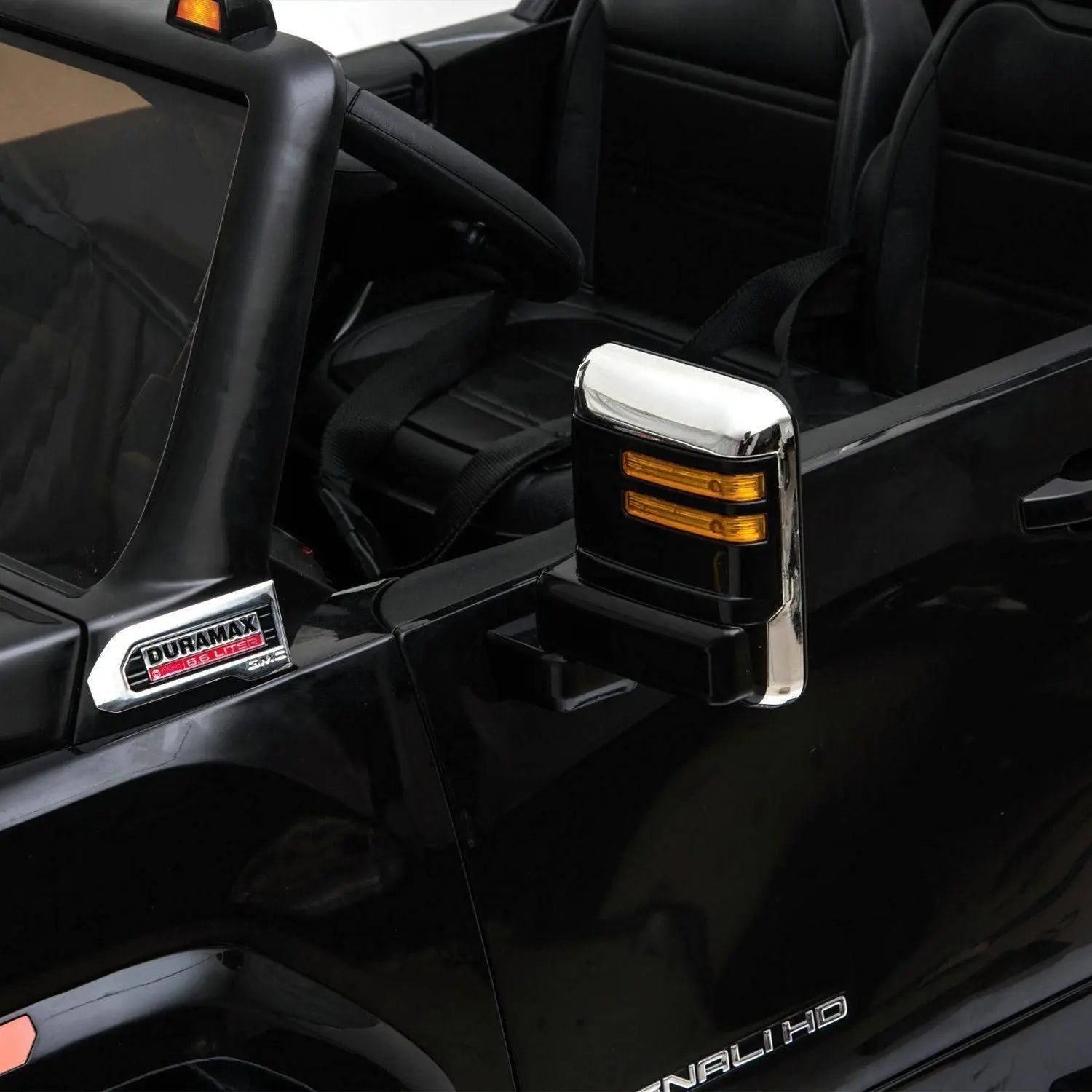 Close-up of black 24V GMC Denali HD 2-seater ride-on toy car with detailed side mirror and seats