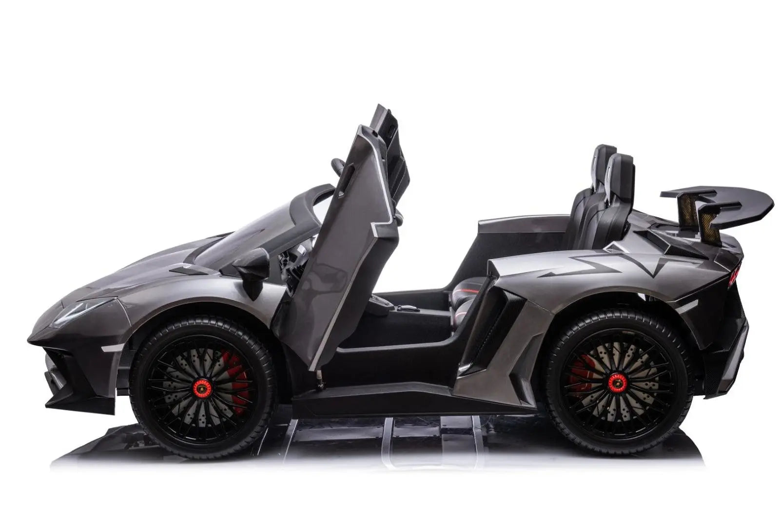 Gray two-seater kids ride-on car styled like a Lamborghini with scissor doors open, side view