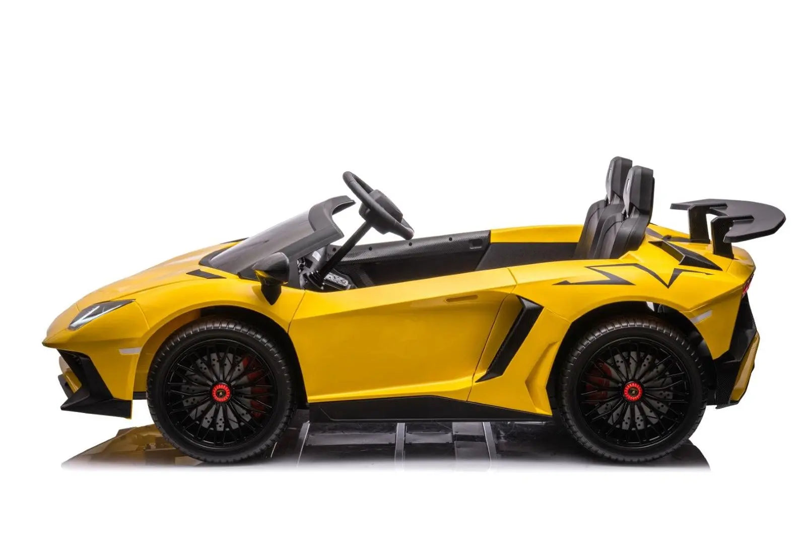 Yellow two-seater kids ride on car with sporty design, black wheels, and rear spoiler