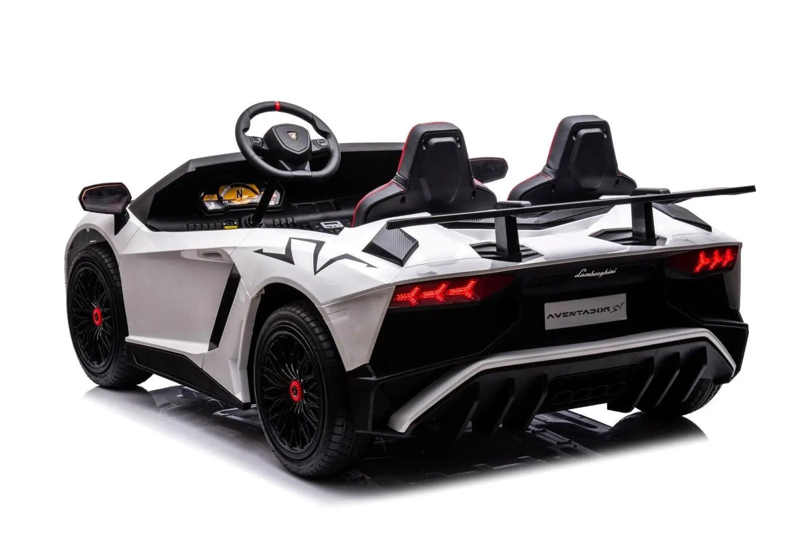 White 2-seater kids ride-on Lamborghini car with rear spoiler and black wheels, rear view