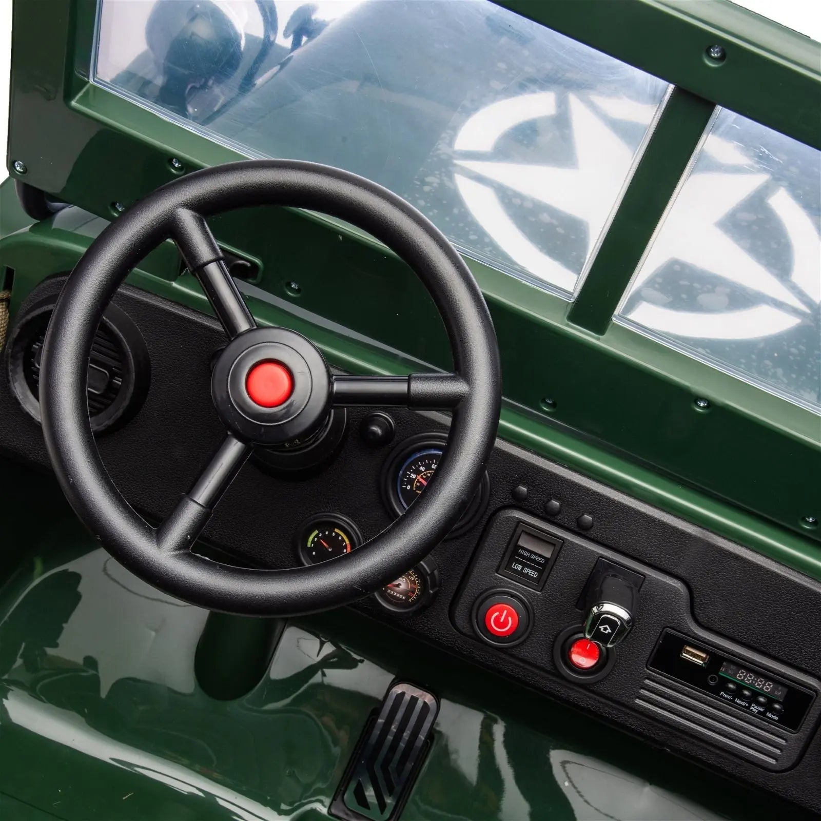 Dashboard and steering wheel of a green kids' electric military Jeep ride-on toy