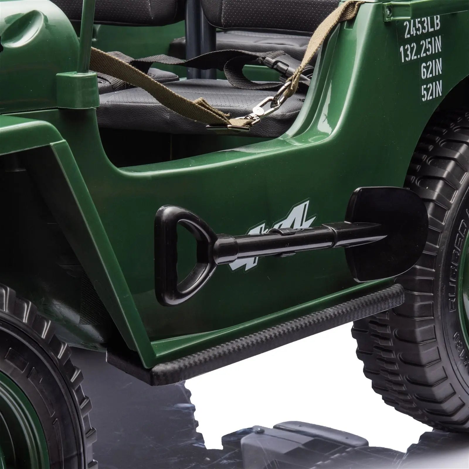 Close-up of green 24V military-style electric ride-on jeep with black shovel and seat belts