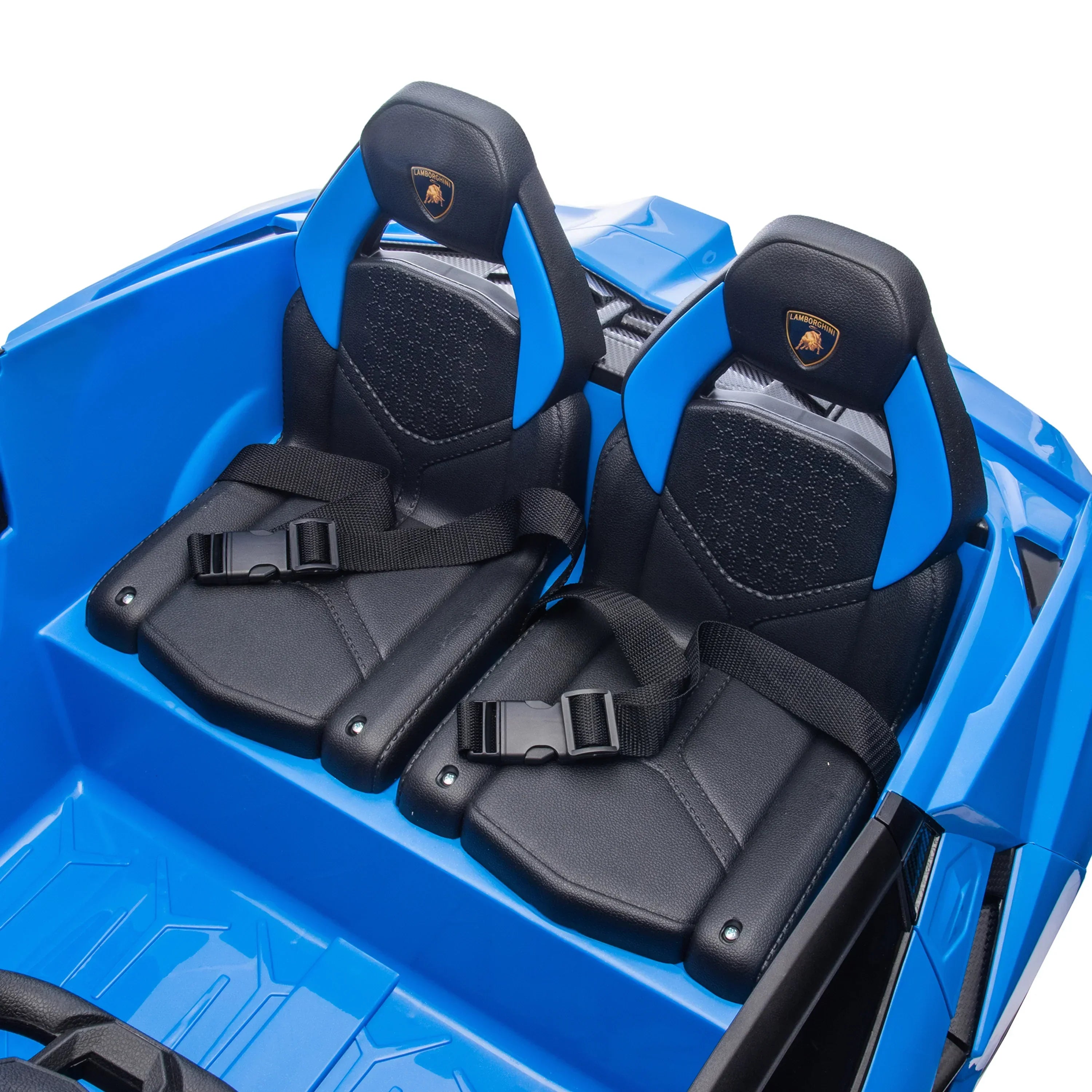 Blue Lamborghini ride-on car with two black leather seats and seat belts