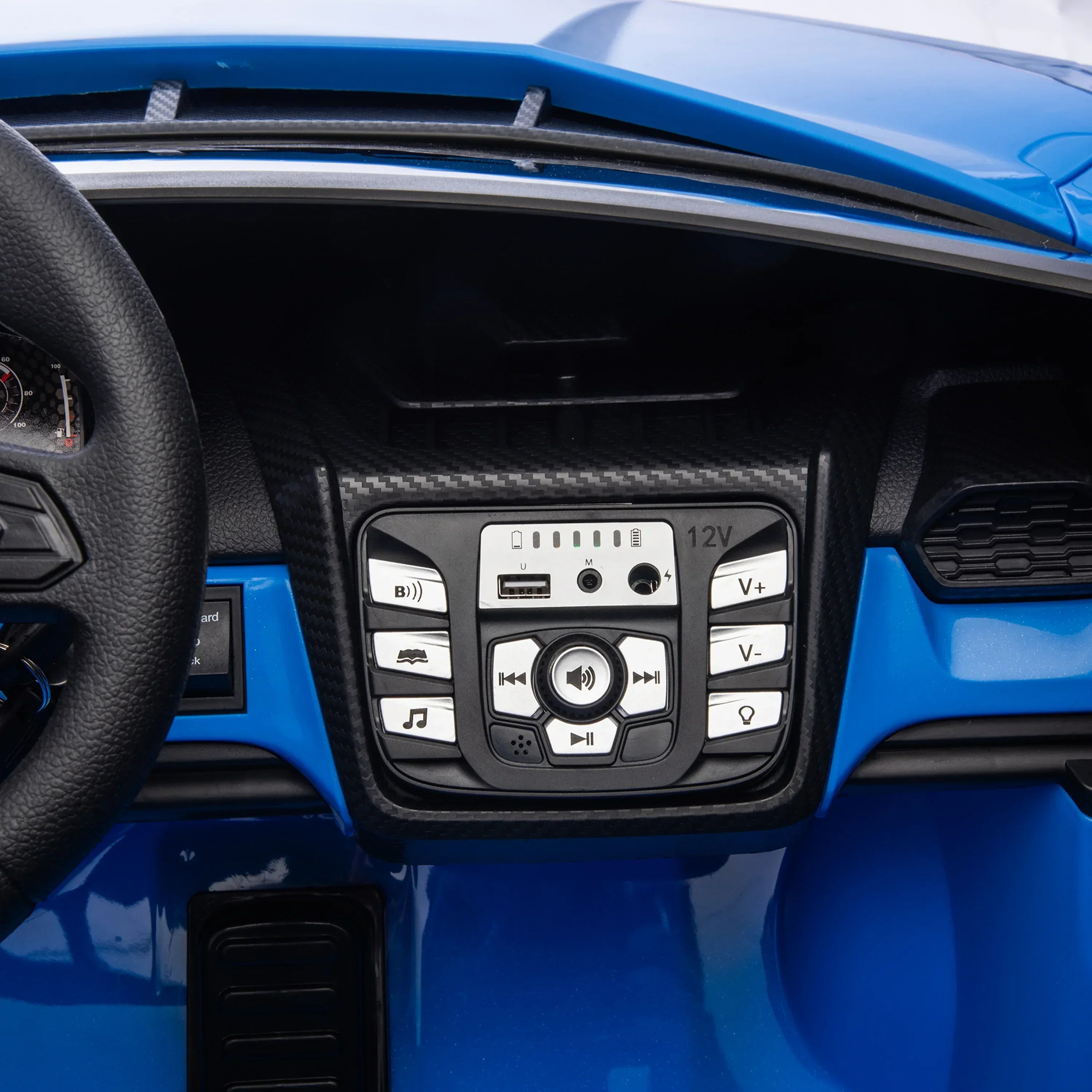Blue toy car dashboard with control panel, buttons, and steering wheel detail.