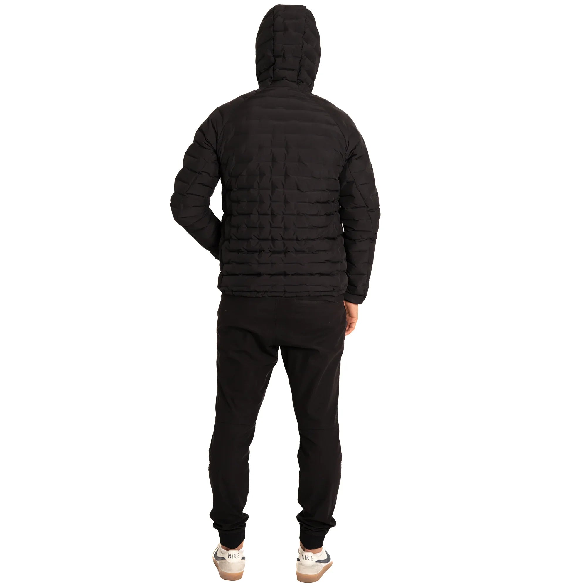 Man in black puffer jacket with hood and black joggers, back view on white background