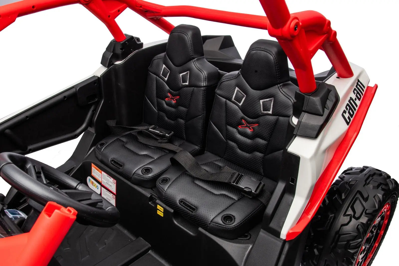 Interior view of a kids' 2-seater Can-Am Maverick ride-on UTV with black bucket seats and safety belts