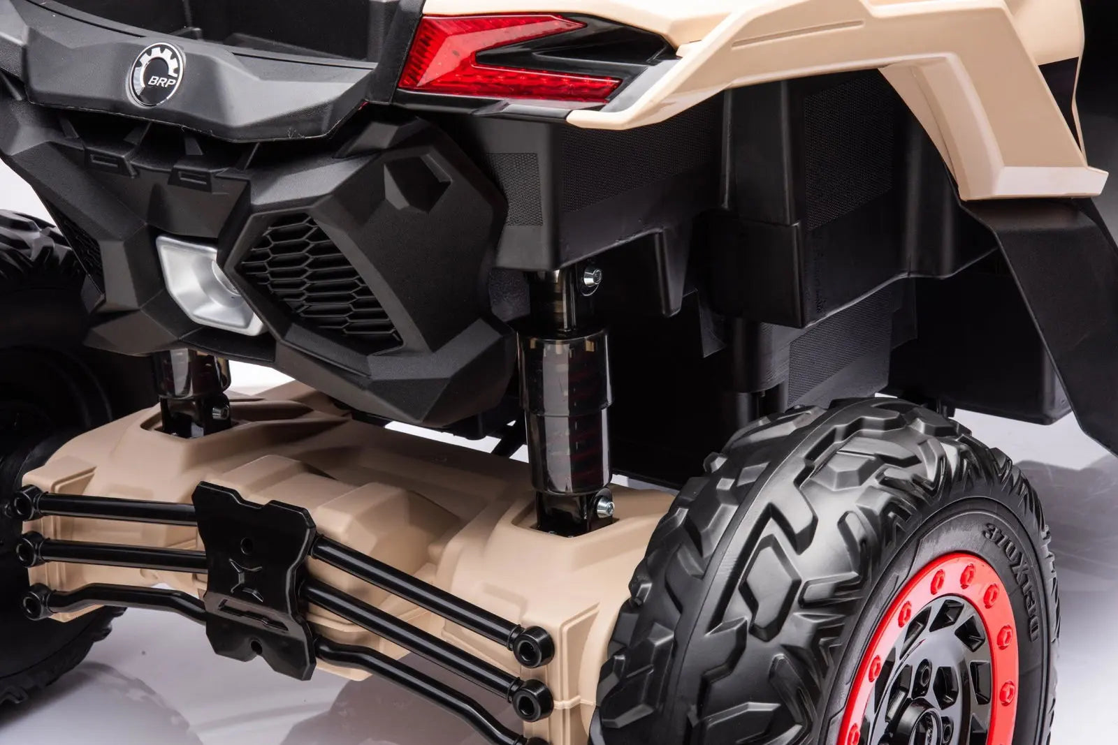 Rear suspension and rugged tire detail of kids’ 4x4 ride-on UTV toy vehicle