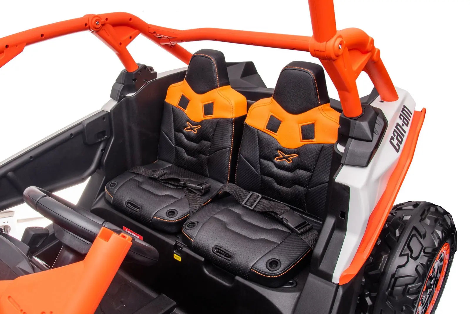 Two-seater kids ride-on UTV with orange and black seats, safety belts, and rugged tires.