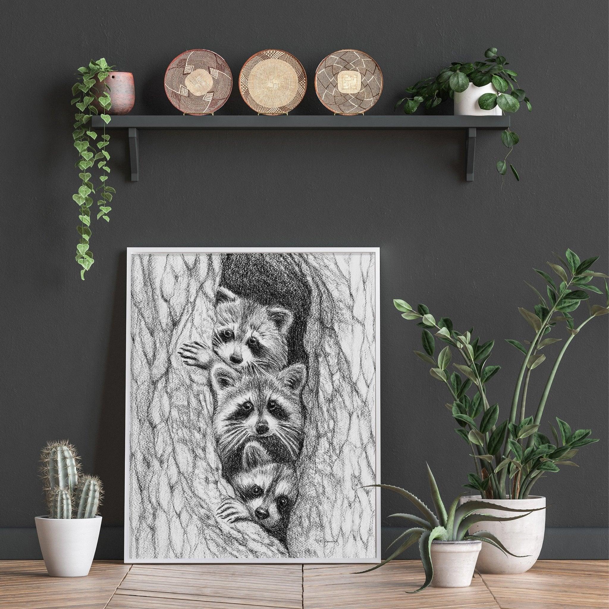 Black and white raccoon drawing in a tree displayed in a modern living room with plants