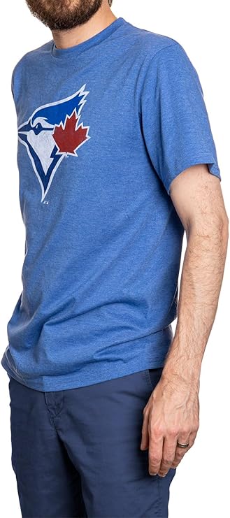Man wearing a blue T-shirt with a bird and maple leaf logo, suitable for outdoor activities.