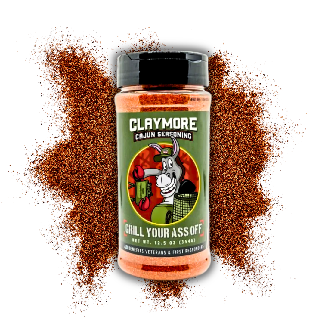 Claymore Cajun seasoning bottle with grill mascot, surrounded by spice powder