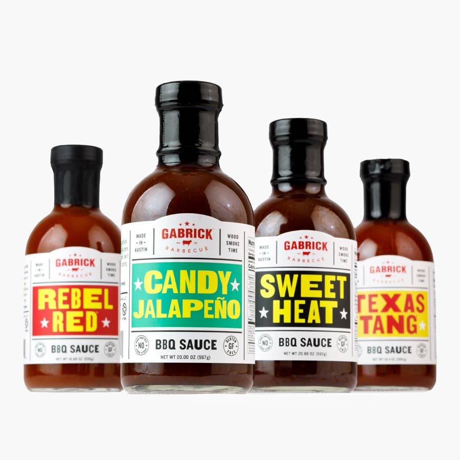 Four Gabrick Barbecue BBQ sauce bottles in assorted flavors, including Candy Jalapeño and Sweet Heat.
