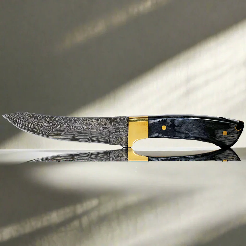 Damascus steel hunting knife with patterned blade and dark wood handle on reflective surface