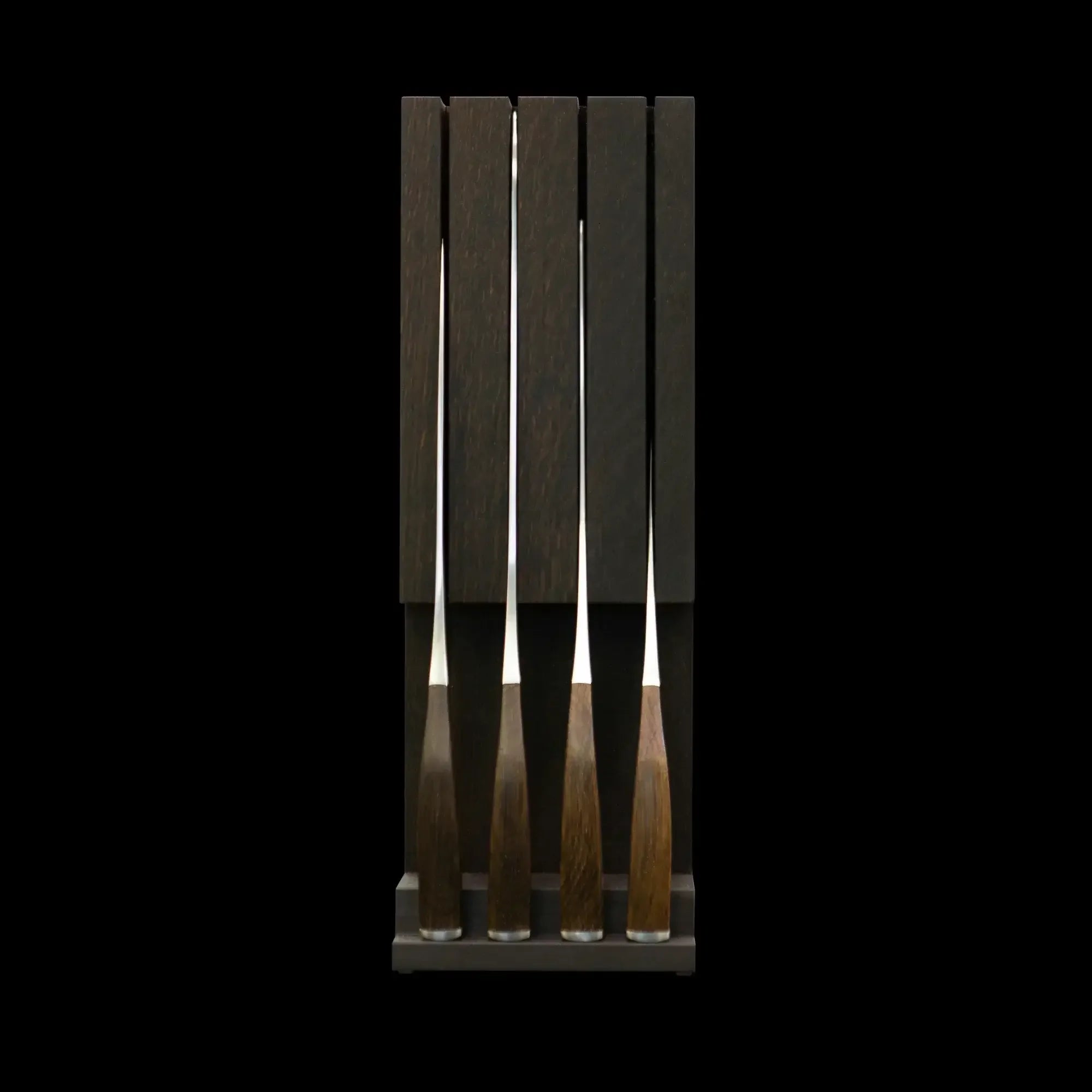 Set of four wood-handled knives in a dark wooden block, camping or outdoor kitchen gear