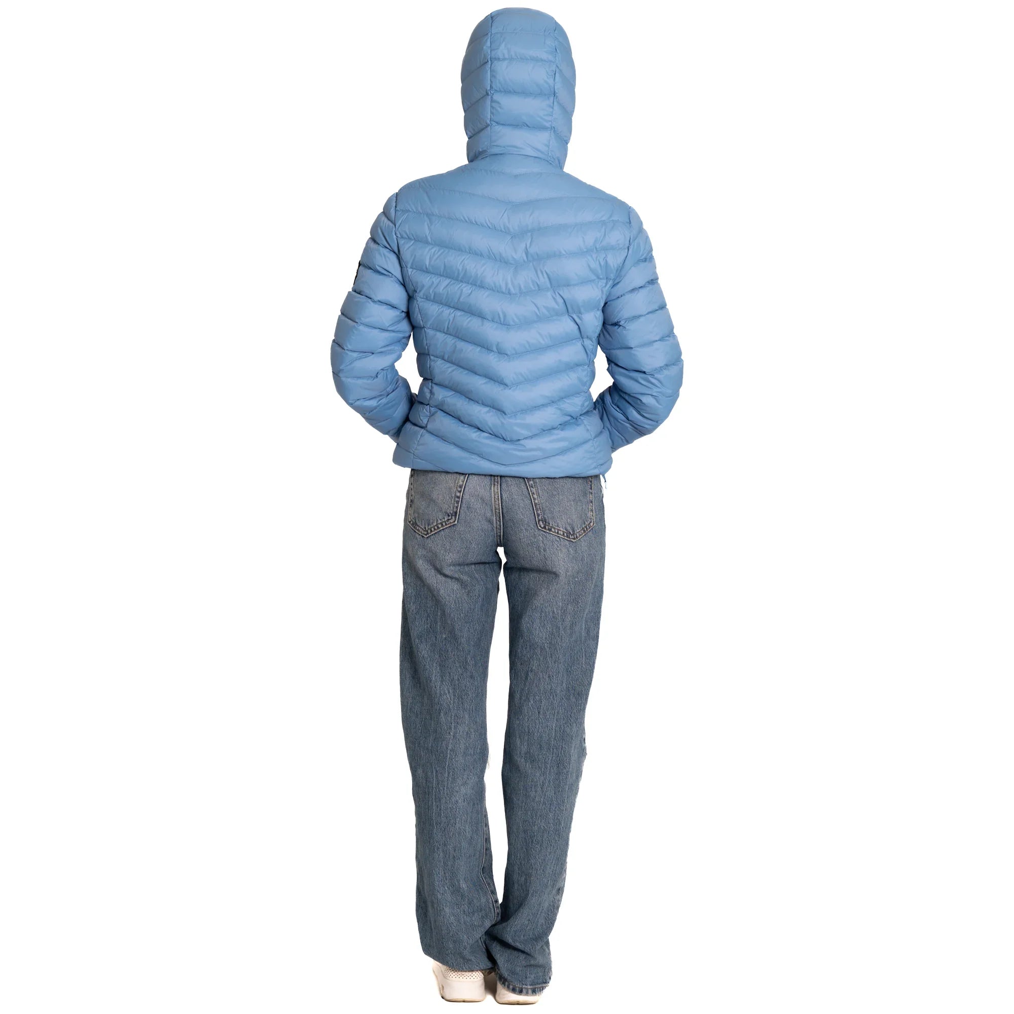 Person wearing blue puffer jacket with hood and jeans, back view on white background