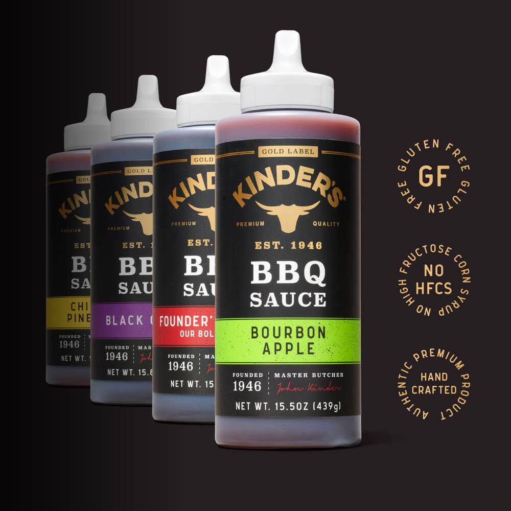 Assorted Kinder's BBQ sauce bottles in flavors like bourbon apple, gluten free, no HFCS.
