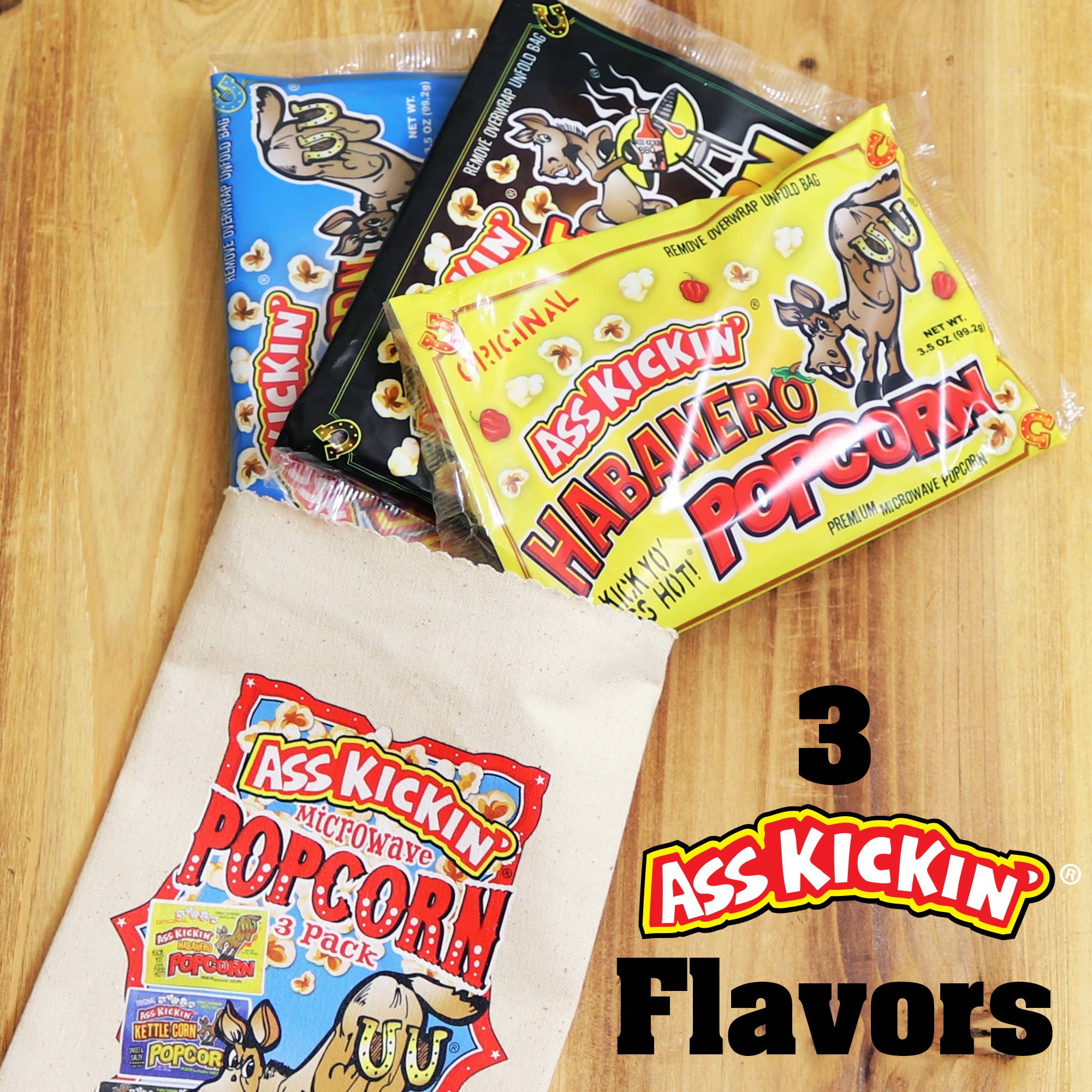Ass Kickin' microwave popcorn variety pack with three spicy flavors on a wooden table