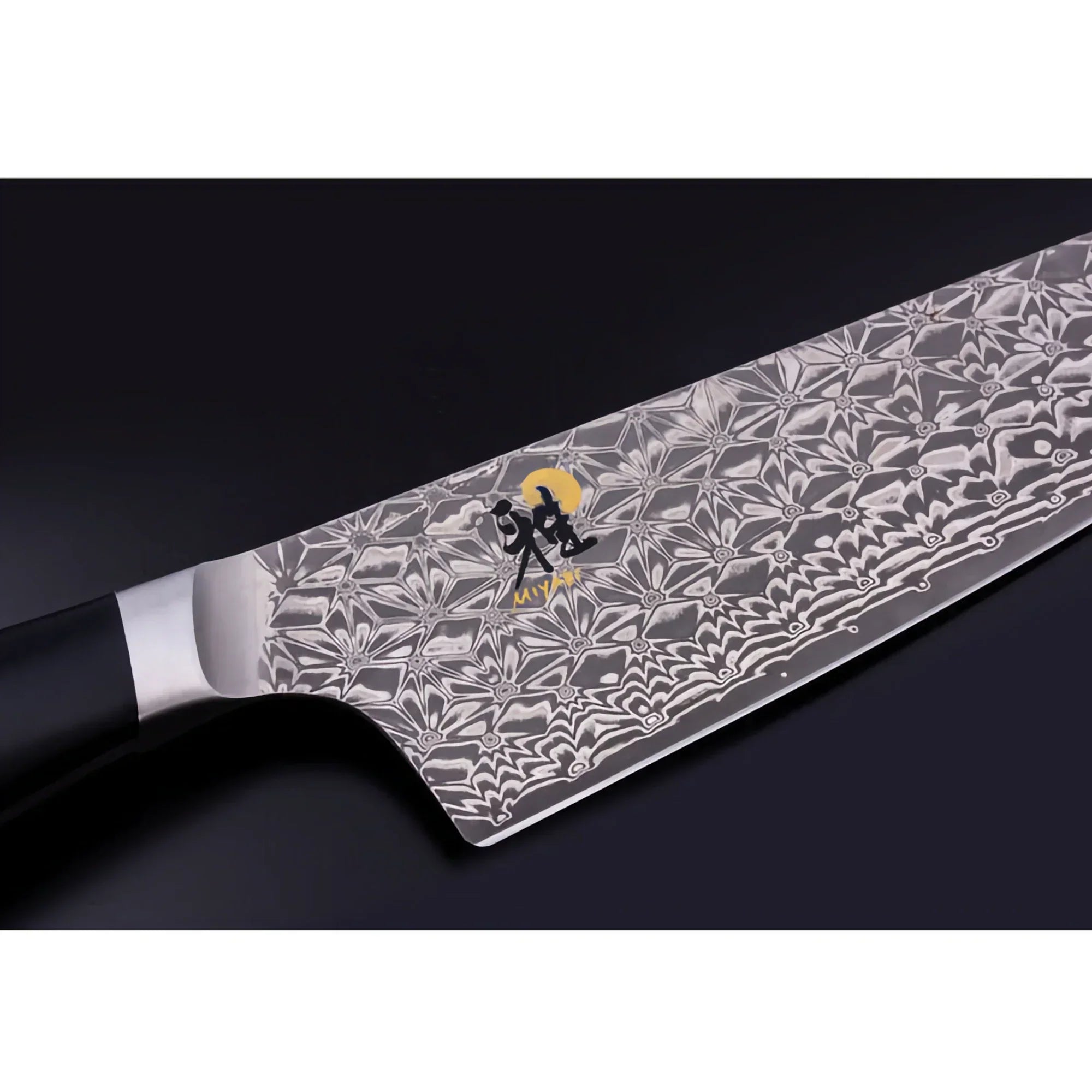 Close-up of a Damascus steel chef knife with intricate pattern and black handle