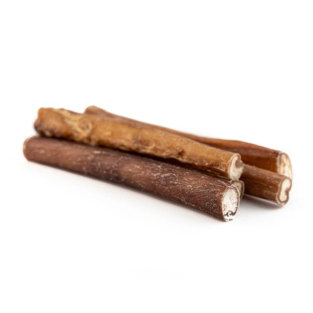 Three standard bully sticks dog chews on a white background
