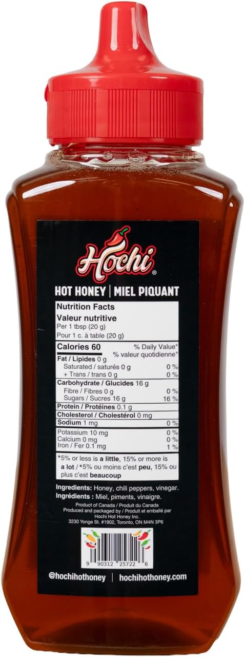 Squeeze bottle of hot honey with red cap, nutrition facts and ingredients label visible