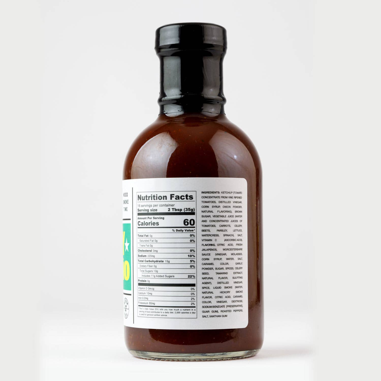 Brown glass condiment bottle with nutrition facts label, isolated on white background