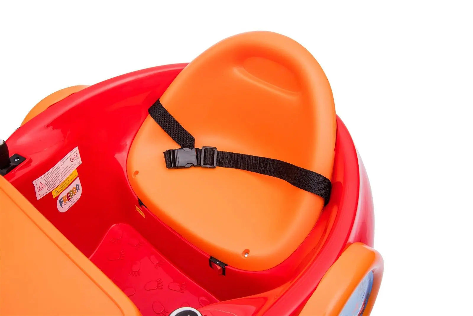 Close-up of orange and red kids bumper car seat with seatbelt and safety label
