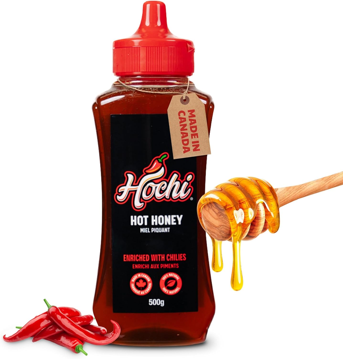 Bottle of Hochi hot honey with chilies and honey dipper on white background
