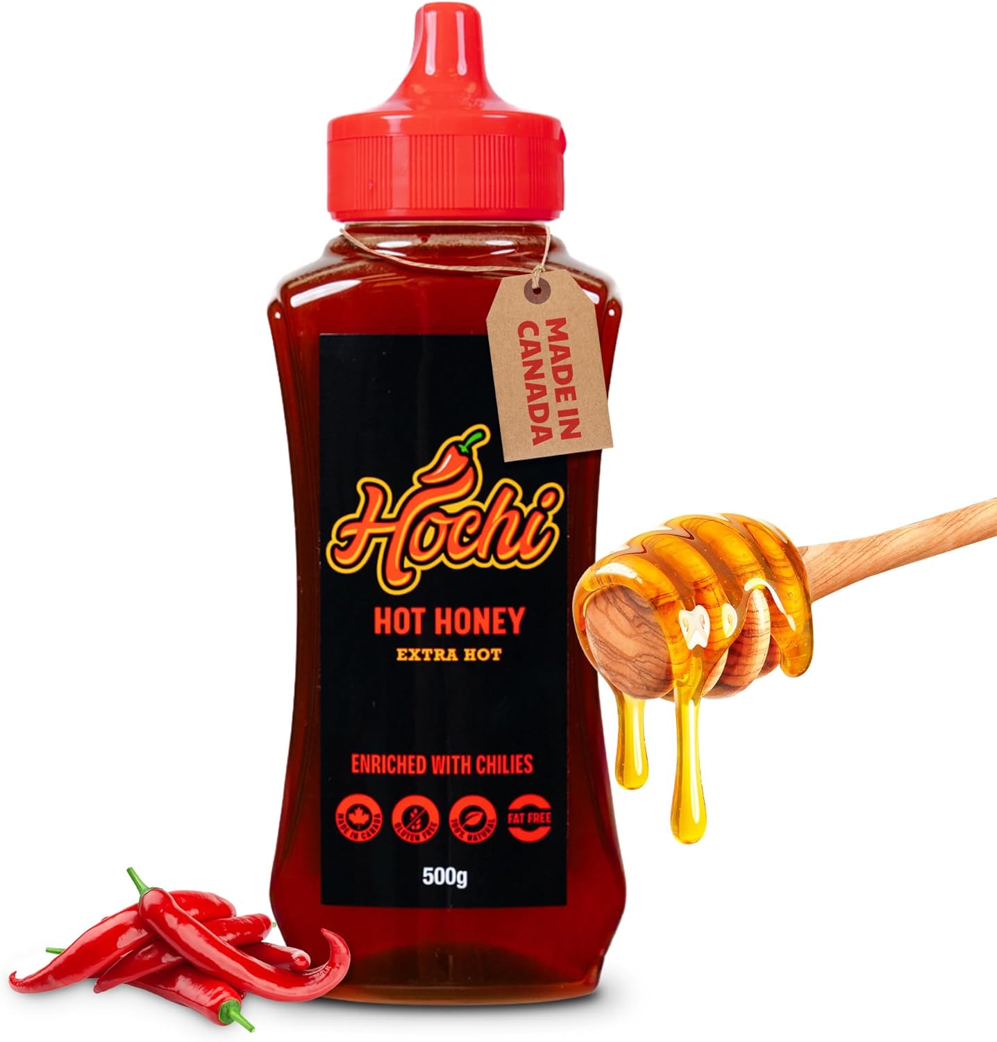 Bottle of extra hot honey with chilies, honey dipper, and red chili peppers.