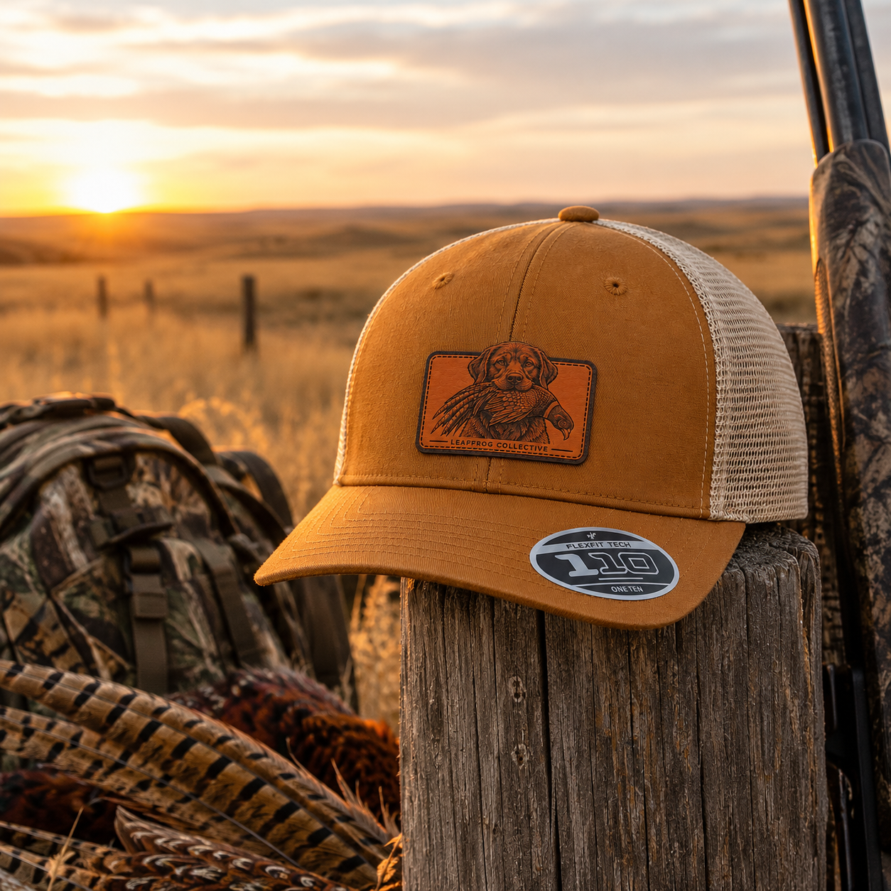 Leapfrog Collective retriever and pheasant hunting hat displayed on a fence post in the Canadian Prairies